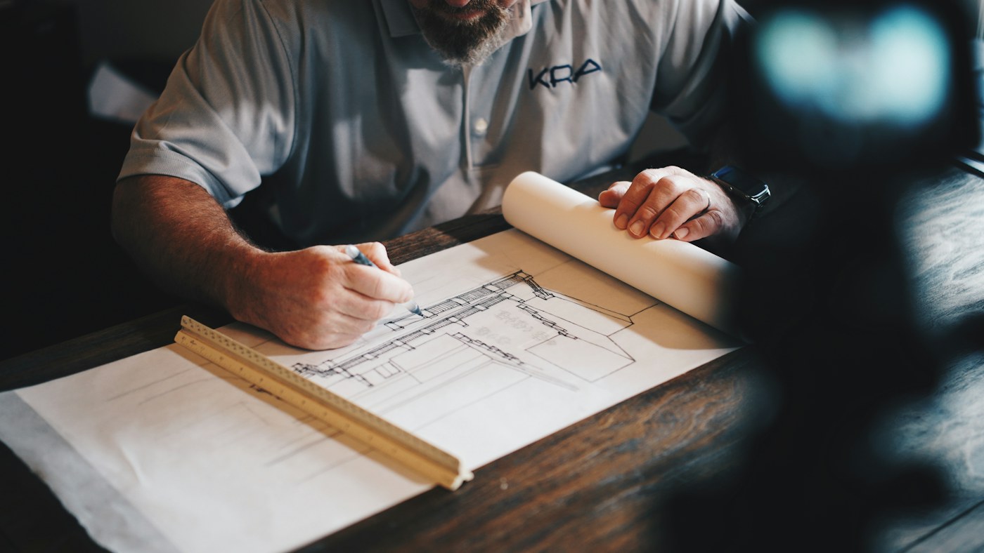 A homeowner and contractor reviewing renovation plans